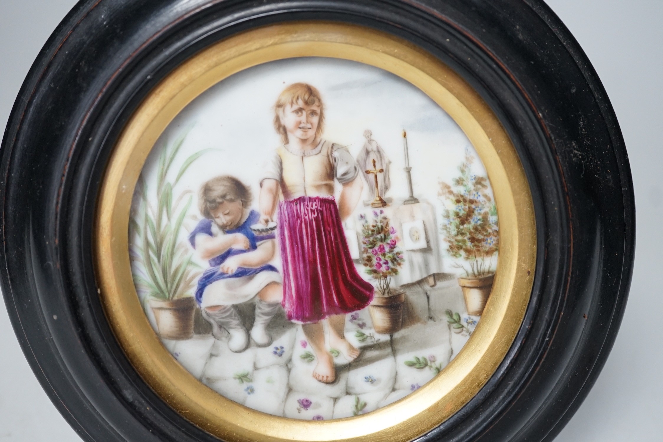 A 19th century Continental porcelain plaque. 16cm diameter overall